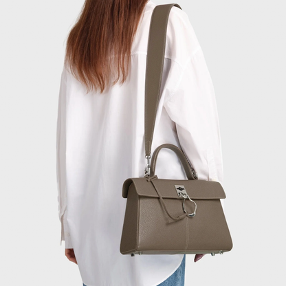 Muted Earthy Taupe Grain Textured Sleek Trapezoid Flap Tote With Distinctive Curved Ring Metal Clasp And Base Protective Studs