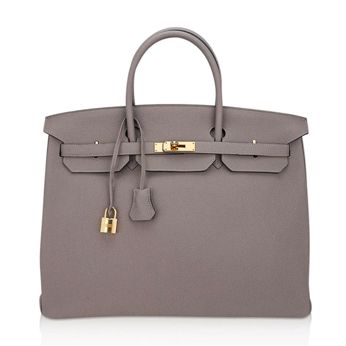 Muted Ash Gray Pebble Grain Large Trapezoid Hand Tote With Warm Polished Golden Twist Lock Hardware And Matching Suspended Engraved Metal Padlock Charm