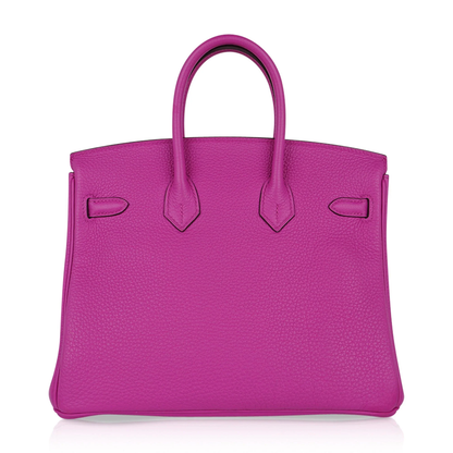 Vivid Saturated Magenta Pebble Grain Compact Trapezoid Hand Tote With Cool Polished Silvery Twist Lock Hardware And Matching Suspended Engraved Metal Padlock Charm